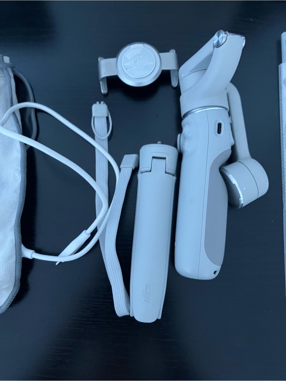 DJI white handheld gimbal stabilizer with accessories